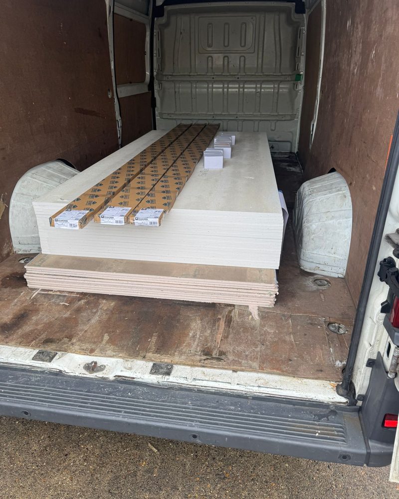 Van load of plasterboard sheets and boxed parts